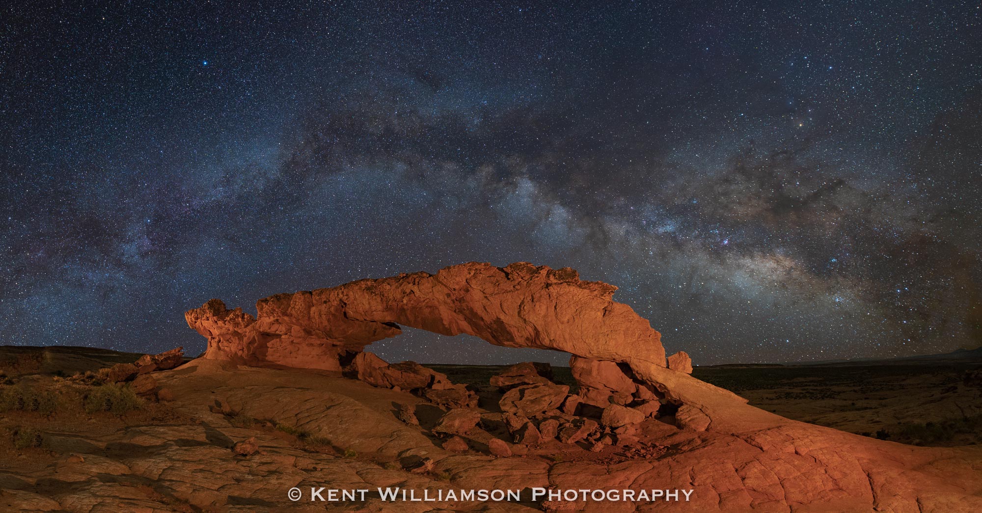 Sunset Arch A clear night over Sunset Arch in Escalante Utah. This image is a nighttime panorama, and has an aspect ratio of 1:192-- the...